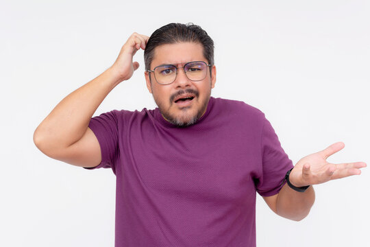 A middle aged man frustrated and looking confused. Wearing a purple waffle shirt. Isolated on a white background.