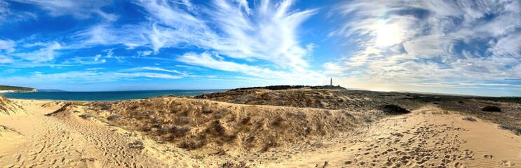 panorama view at Faro de Trafalgar, lighthouse at a sandy dune headland between Los Caños de Meca...