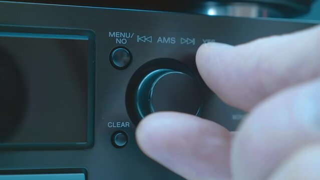 A man writes by round knob song titles and other necessary information into the minidisc (MD) menu track, an advanced system at that time. Closeup. Macro. Shot in motion. Accelerated