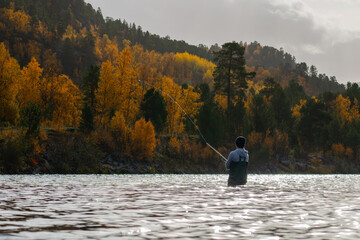 Fototapeta na wymiar A salmon fisherman in a salmon river in Norway