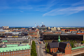 Fototapeta na wymiar The Holmen Church (Danish: Holmens Kirke) is a former naval church in center of Copenhagen, Denmark. Amager Bakke incineration plant on the background. View from the tower of Christiansborg Palace