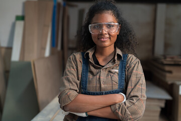 Portrait of female carpenter in wood workshop. Concept of wood workshop industrial factory