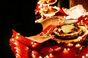 Cutting a cake with a glowy red background