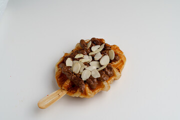 Homemade Croffle with Hazelnuts sauce, almioonds, nuts, and Chocolate - Tempting Gourmet
