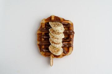 Homemade Croffle with Hazelnuts sauce, Banana, and Chocolate - Tempting Gourmet