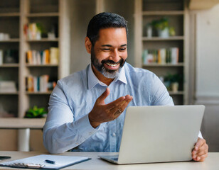 Happy mature business man executive manager looking at laptop computer watching online webinar or having remote virtual meeting, video conference call negotiation