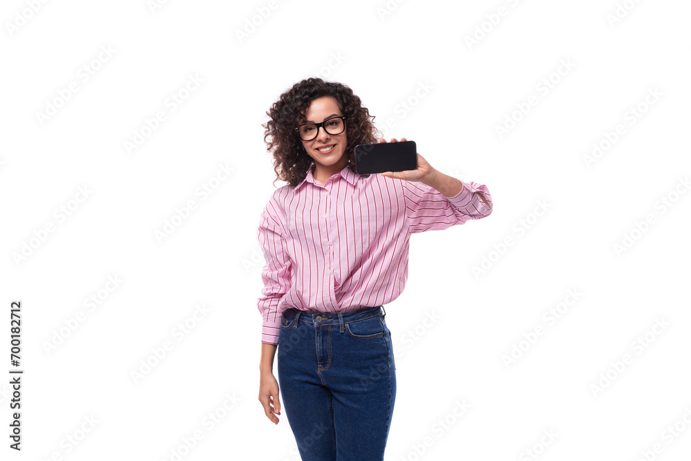 Wall mural young slender caucasian woman leader holding smartphone mockup. advertising concept