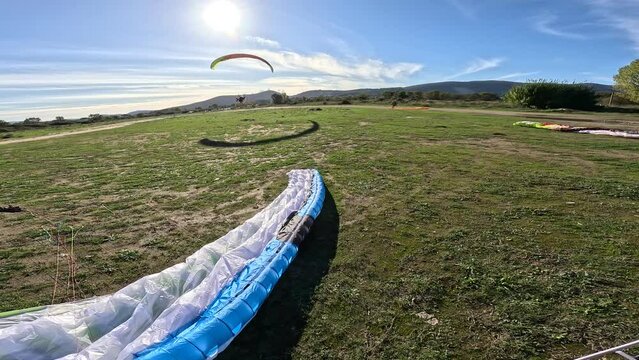 Powered paragliding- paramotor take off with powered paraglider two-stroke engine and paragliding wing froma  field airplane