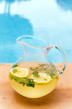 Fresh pitcher of mint lemonade by the pool