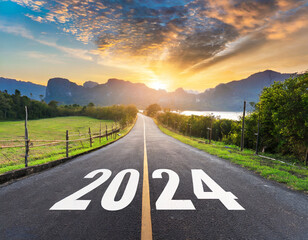 2024, the new year 2024 or the beginning of the concept of the word 2024, written on a road in the middle of a paved road with a sunset mountain backdrop Planning ideas and challenges