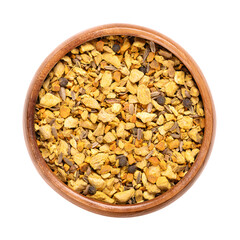 Ginger and turmeric herbal tea, in a wooden bowl. Mix of the dried and shredded anti-inflammatory spices ginger, turmeric, and galangal. Whole fennel seeds and black peppercorns were also added. Photo