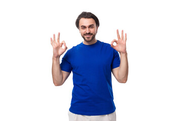 young handsome european man with black hair and beard dressed in a blue t-shirt