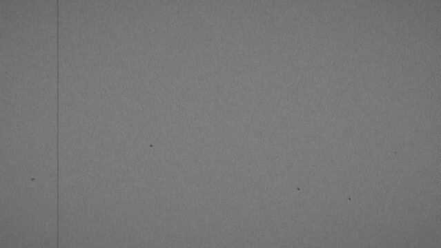 Old film look with scratches, old TV film Look overlay, old film look effect with a dirt, grain texture,vintage realistic flickering. Film grain with light leaks in 4K. Use opacity or screen mode