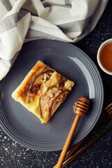 freshly baked homemade pastries. Puff pastry mini tart with pear slices, camembert, honey, walnuts top view