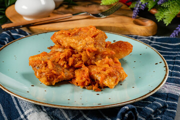 Fish in Greek kind with vegetables and tomato sauce.