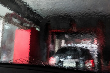 Water in carwash splashing on car window.  Car wash concept