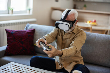 Vr, gaming and senior man in virtual reality in home on sofa in living room, laughing and having fun. 3d metaverse, esports gamer and happy retired male playing futuristic games with controller.