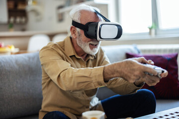 Vr, gaming and senior man in virtual reality in home on sofa in living room, laughing and having...