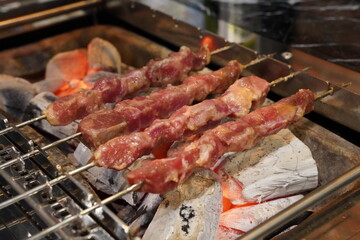 Grilled lamb skewers grilled over charcoal fire
