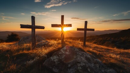 three wooden chrsitian crucifix crosses on hill at sunset