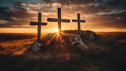 Fotobehang three wooden chrsitian crucifix crosses on hill at sunset © Barosanu