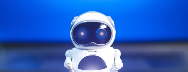 Real white small Robot on black table. Futuristic future technology. Business helper for...