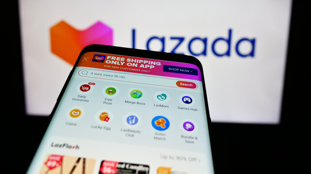 Stuttgart, Germany - 12-20-2023: Smartphone with website of Asian e-commerce company Lazada Group in front of business logo. Focus on top-left of phone display.