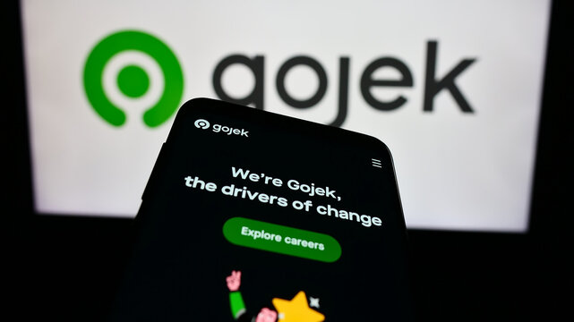 Stuttgart, Germany - 12-20-2023: Smartphone with website of technology company PT Gojek Indonesia in front of business logo. Focus on top-left of phone display.