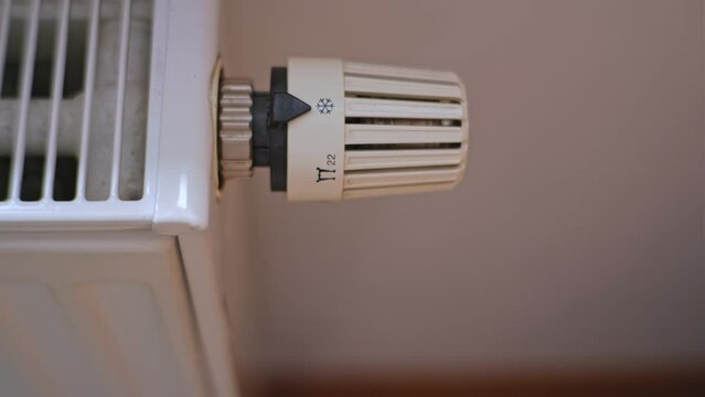 Caucasian Male Turning Up and Down Room Heater Using Thermostat Temperature Regulator Knob