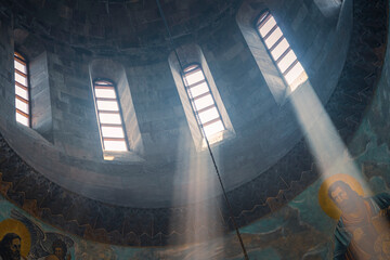 The sunlight shines through the narrow windows of the church. Travel in Armenia