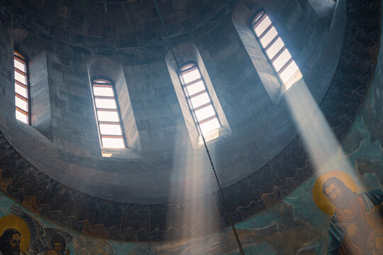 The sunlight shines through the narrow windows of the church. Travel in Armenia