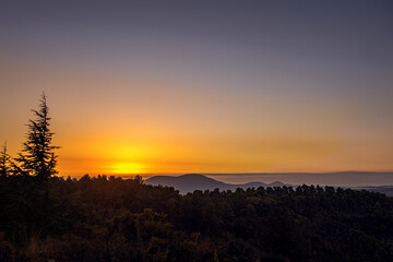 beautiful background of blazing sunset in the mountains golden hour
