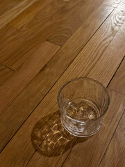 Empty Highball glass on a wooden bar top