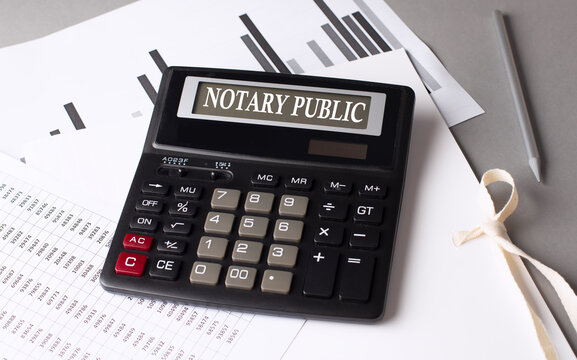NOTARY PUBLIC text on calculator with chart on grey background