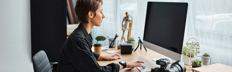 professional female photographer in casual wear retouching photos on computer at her studio, banner