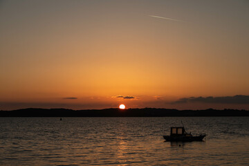 sunset in Croatia with a silhouette of a boat in the ocean