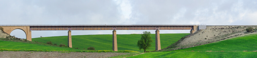 Ancient Viaduct Bridge Over Green Countryside