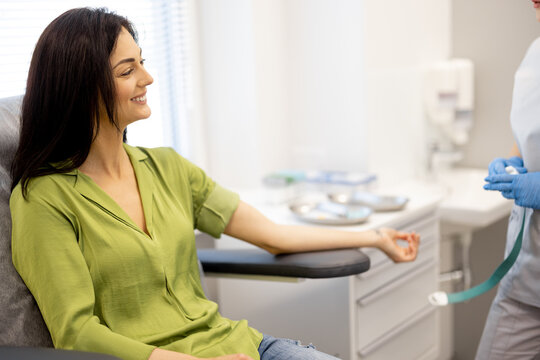 Exhausted woman is waiting for blood tests to be taken while sitting in the laboratory