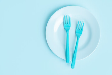 Food concept with children cutlery on blue background