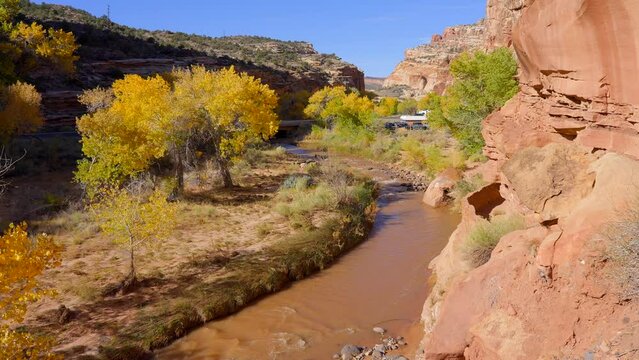 Establishing shot of mountain trail with red rocks in Hickman Natural Bridge Trail, Capital Reef National Park, Utah, North America. ProRes 422 HQ.