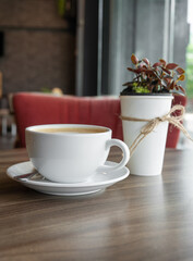 Closeup coffee cup on wooden table in coffee shop