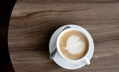 Close-up white coffee cup on wooden table in coffee shop, Top View.