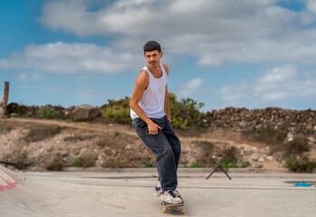 Fototapeta na wymiar young man skating in a skate park