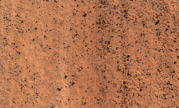 The lateritic soil represent the surface background and texture concept related idea. Country roads filled with Laterite soil. red soil