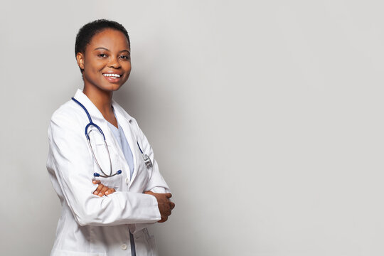 Successful happy doctor woman medical worker in lab coat on white background