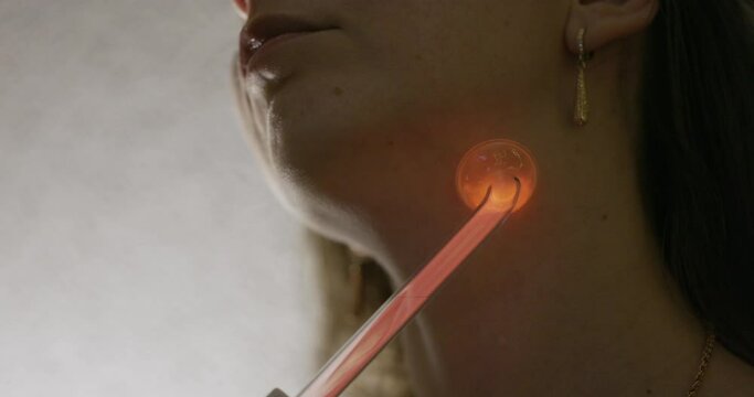 Skin Care. Woman receives a Procedure using the Darsonval device at home. Close-up of the Skin. Concept of professional Cosmetology