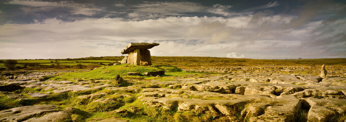 Poulnabrone Dolmen in Burren, county Clare, Ireland. Exposed karst limestone bedrock at the Burren National Park. Neolithic age capstone portal with spectacular landscape. High resolution panorama. - obrazy, fototapety, plakaty
