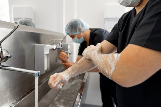 Two surgeons carefully washe hands in preparation for a surgical operation. Concept of sterility and surgery
