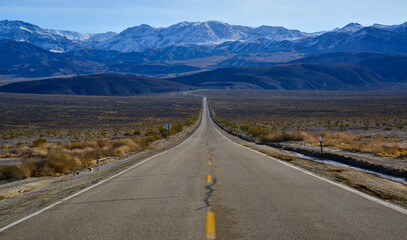Straight Road in the California desert, going into the mountains near Death Valley National Park