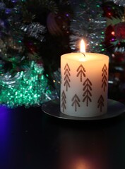 burning candle and christmas tree